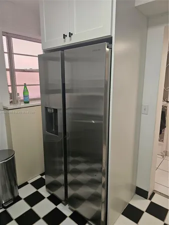a kitchen with a stove a sink and a refrigerator