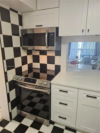 a kitchen with cabinets appliances and a sink