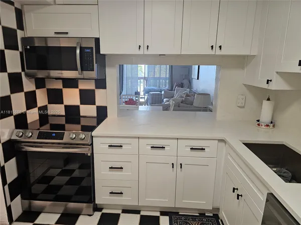 a kitchen with a sink a stove and a refrigerator