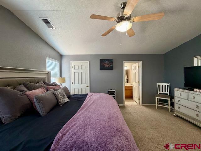 544 20th Street Delta, CO 81416 - Photo 23 of 44 a spacious bedroom with a bed and a chandelier