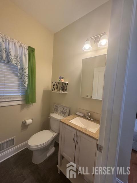 354 Cliff Road, Unit 2 Sewaren, NJ 07077 - Photo 5 of 11 a bathroom with a toilet sink and mirror