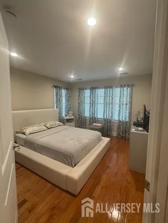 a spacious bedroom with a bed and large window