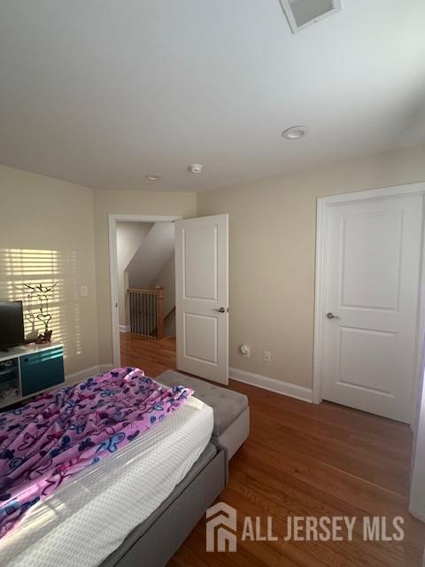 354 Cliff Road, Unit 2 Sewaren, NJ 07077 - Photo 9 of 11 a bedroom with a large bed and a dresser