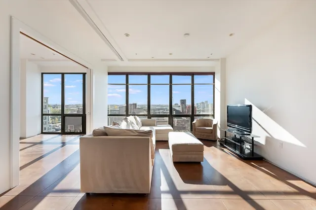 a living room with furniture and large windows