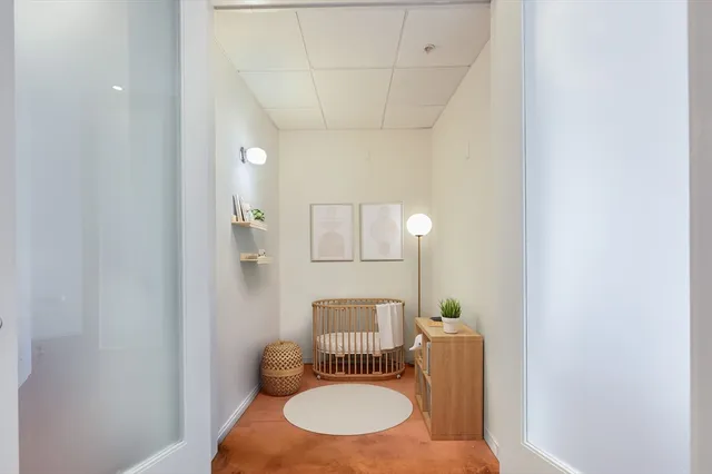 a bathroom with a toilet mirror and vanity