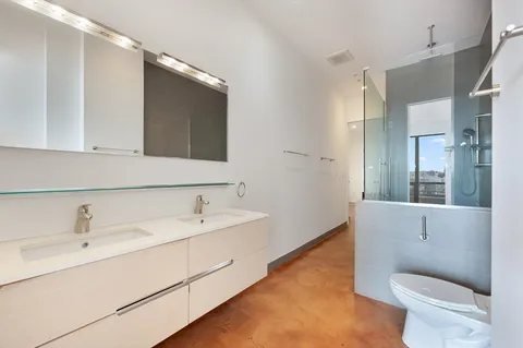 a bathroom with a toilet sink and mirror