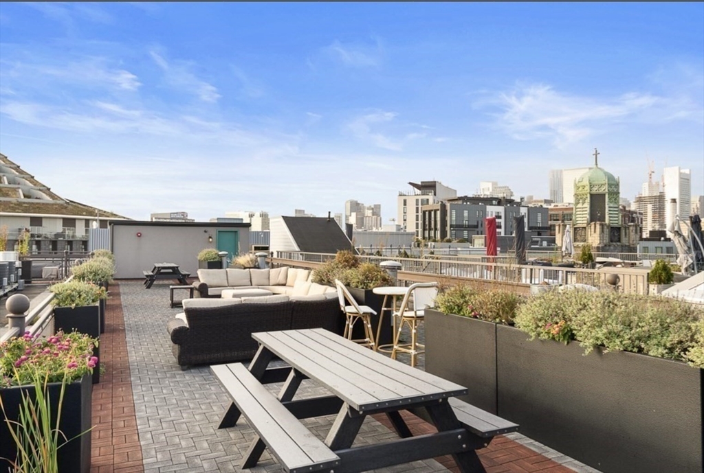 36 A Street, Unit 5D Boston, MA 02127 - Photo 17 of 21 a view of a terrace with furniture and stove
