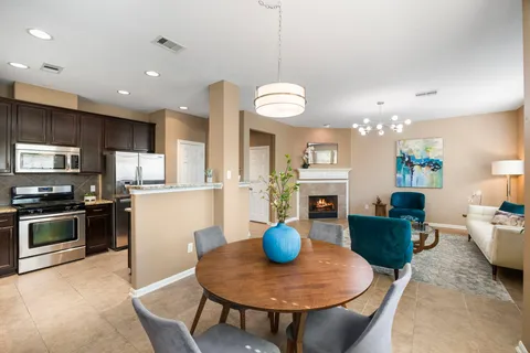 a view of a dining room with furniture and a kitchen