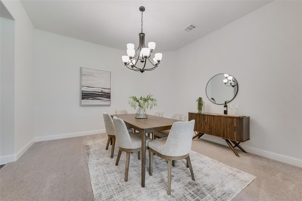 704 Toby Trail Mansfield, TX 76063 - Photo 13 of 40 Dining area featuring light colored carpet and a chandelier