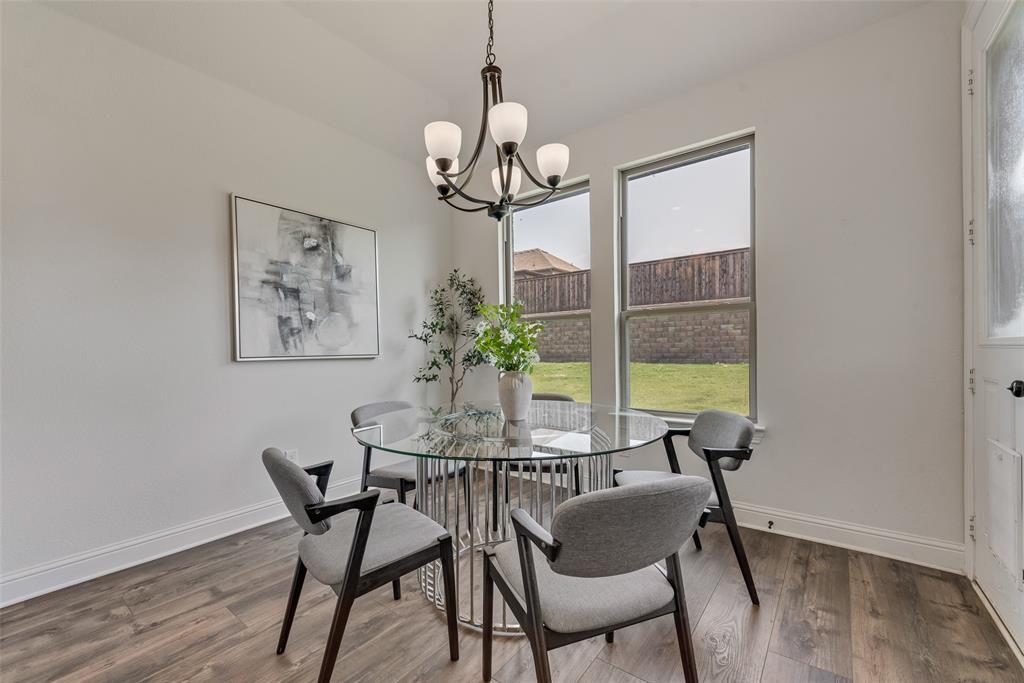 704 Toby Trail Mansfield, TX 76063 - Photo 18 of 40 Dining space featuring wood finished floors and a chandelier