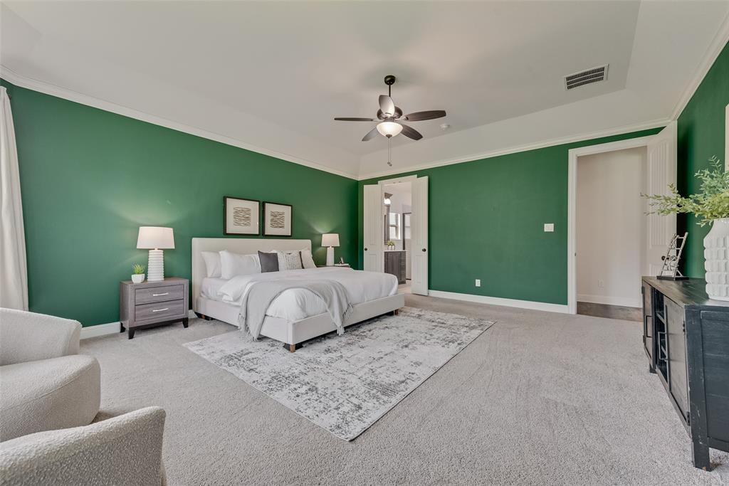 704 Toby Trail Mansfield, TX 76063 - Photo 25 of 40 Bedroom with ensuite bath, light colored carpet, ceiling fan, and crown molding