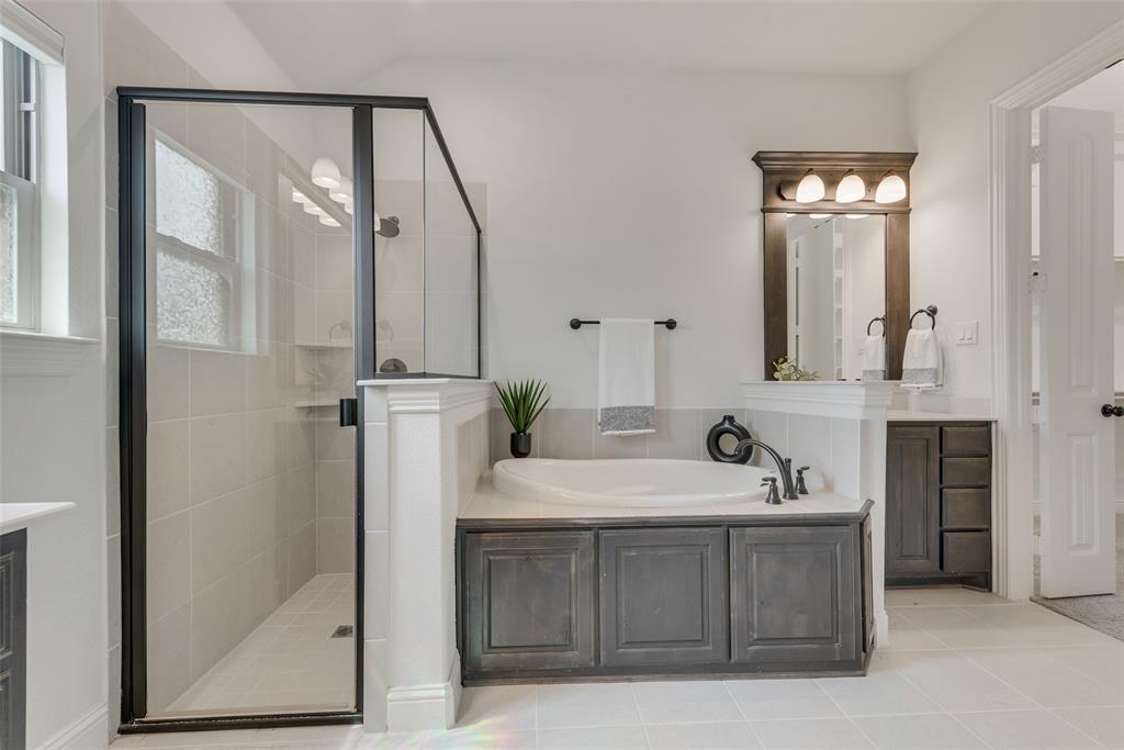 704 Toby Trail Mansfield, TX 76063 - Photo 28 of 40 Bathroom featuring a bath, a shower stall, vanity, and light tile patterned floors