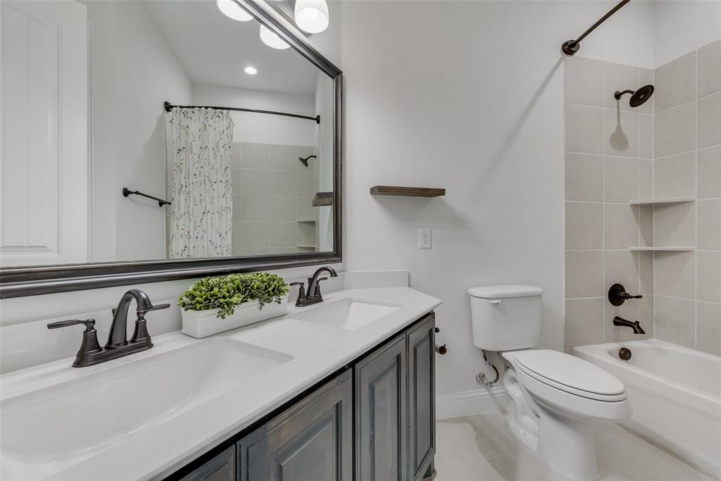 704 Toby Trail Mansfield, TX 76063 - Photo 31 of 40 Full bath with shower / bath combination with curtain, double vanity, and light tile patterned floors
