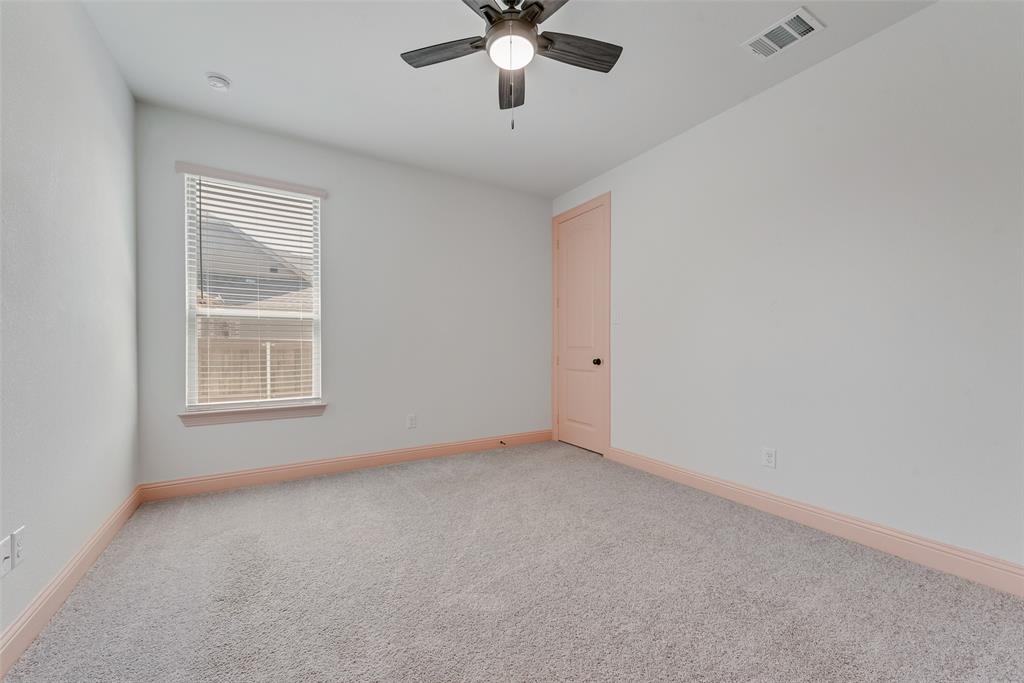 704 Toby Trail Mansfield, TX 76063 - Photo 32 of 40 Carpeted spare room with baseboards and a ceiling fan