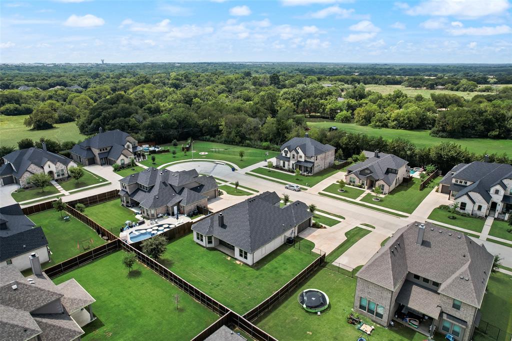 704 Toby Trail Mansfield, TX 76063 - Photo 8 of 40 Aerial view of residential area featuring a heavily wooded area