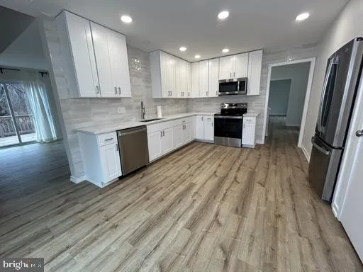 a large kitchen with a white stove top oven and refrigerator