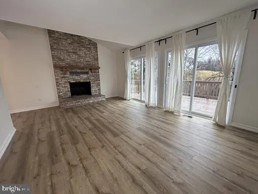 a view of a roof deck with wooden floor and fence