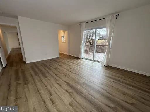 a view of a room with wooden floor