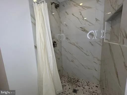 a bathroom with a shower sink and mirror