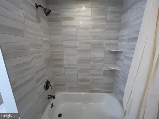 a bathroom with a granite countertop toilet a sink and a shower