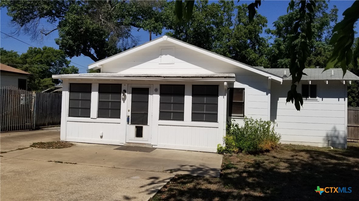 1123 West Coll Street New Braunfels, TX 78130 - Photo 3 of 24 a front view of a house with a garden and parking