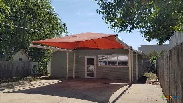 a backyard of a house with seating space