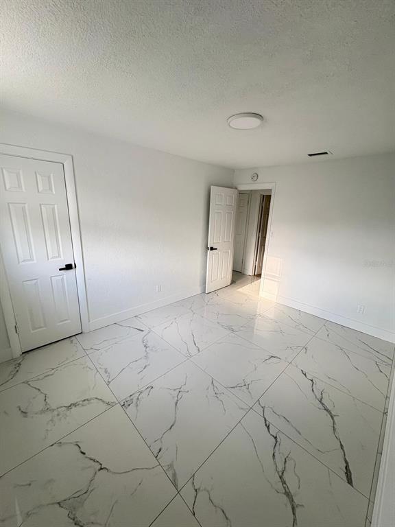 723 Fairmount Road Daytona Beach, FL 32114 - Photo 5 of 9 an empty room with a natural light