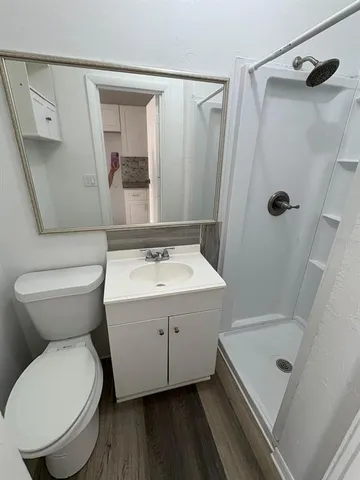 a bathroom with a sink toilet and shower