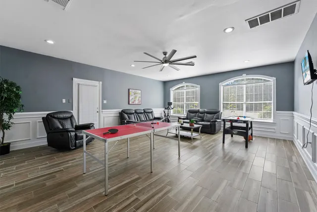 a living room with furniture window and wooden floor