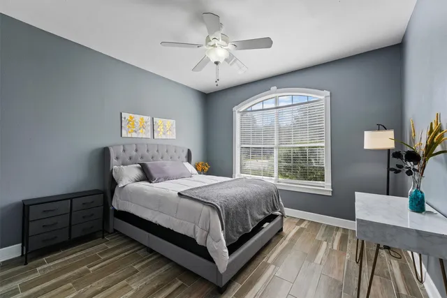 a bedroom with a large bed and a chandelier