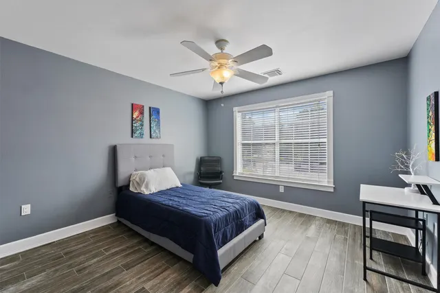 a living room with a bed furniture and a window