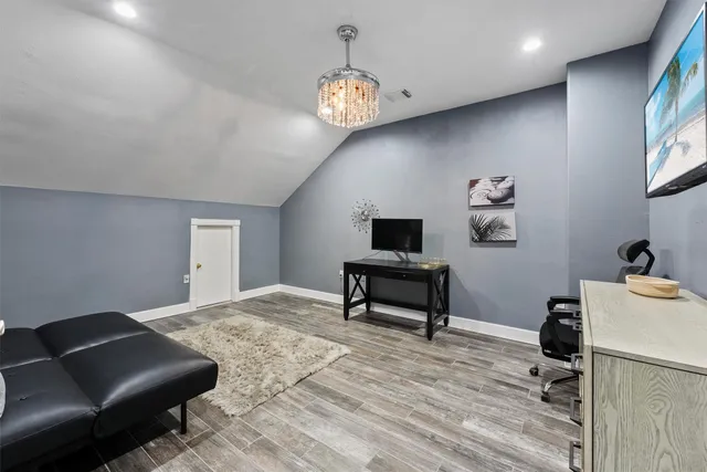 a living room with furniture and a chandelier