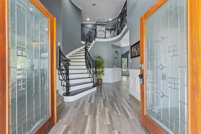 a view of entryway and hall with wooden floor