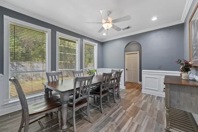 a view of a dining room with furniture and wooden floor