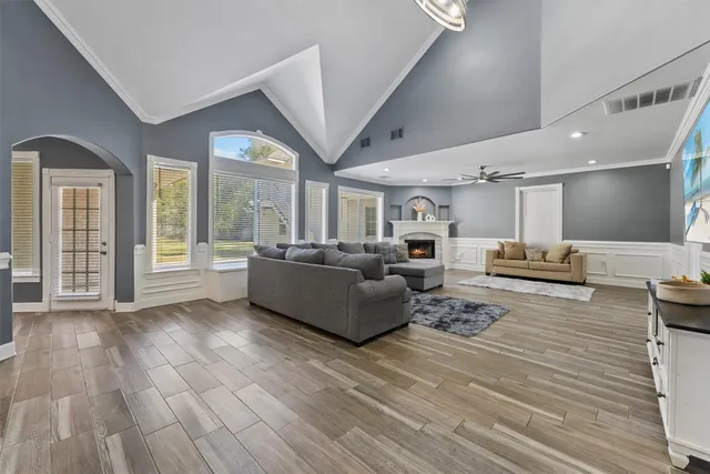 a living room with furniture window and wooden floor