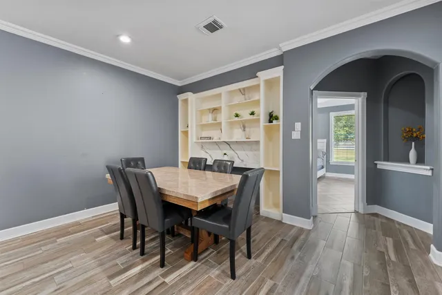 a view of a dining room with furniture and wooden floor
