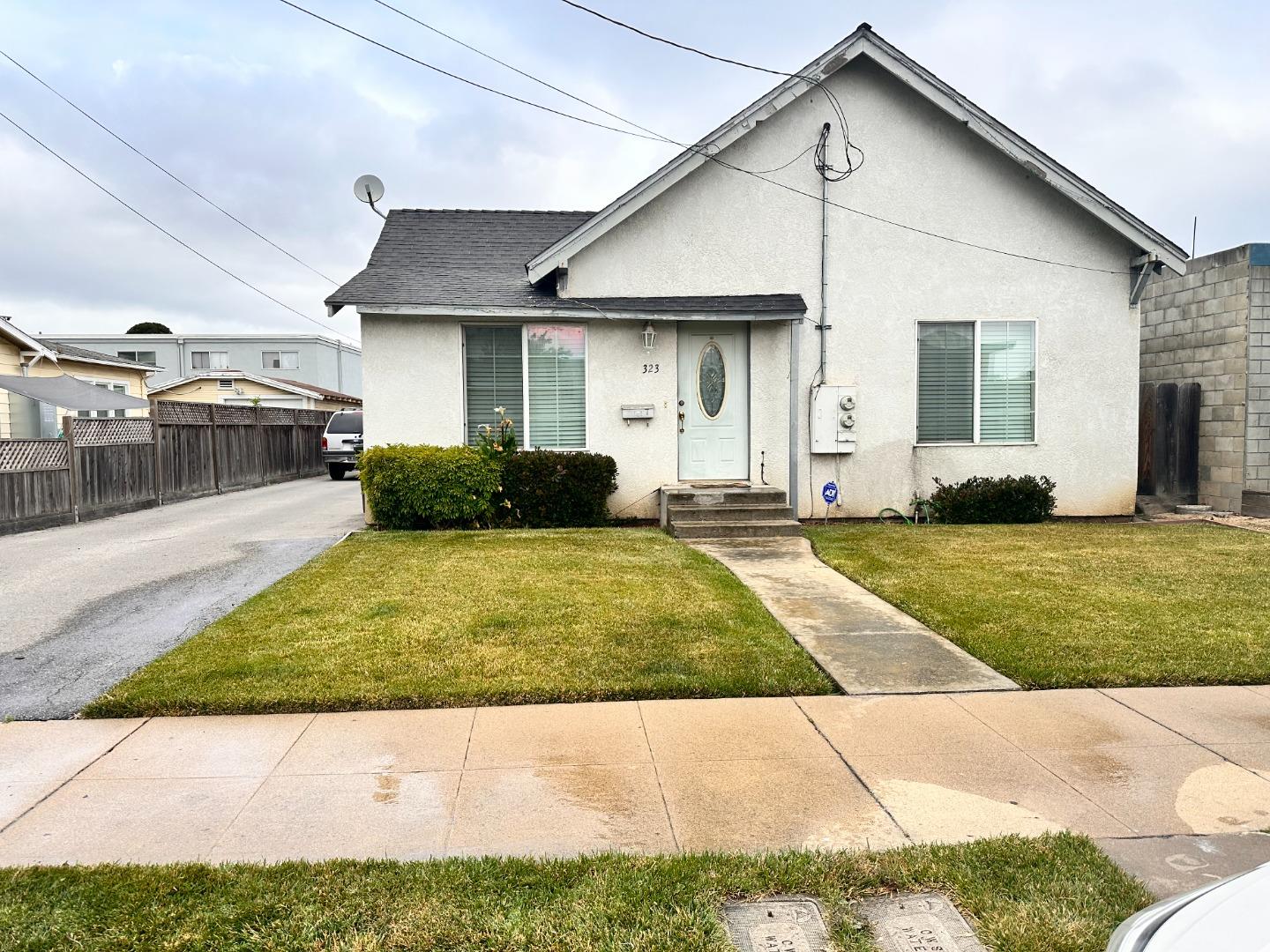 a view of a white house with a yard