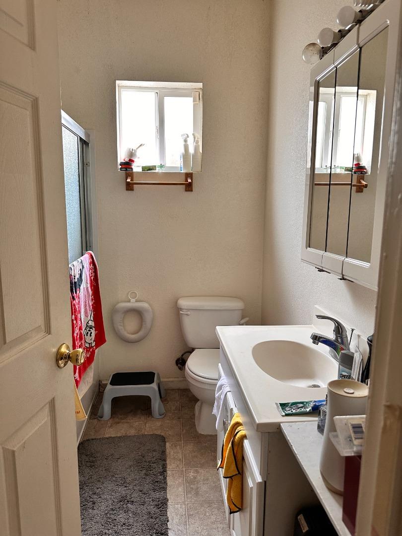 323 Maple Street Salinas, CA 93901 - Photo 3 of 15 a bathroom with a sink toilet and mirror