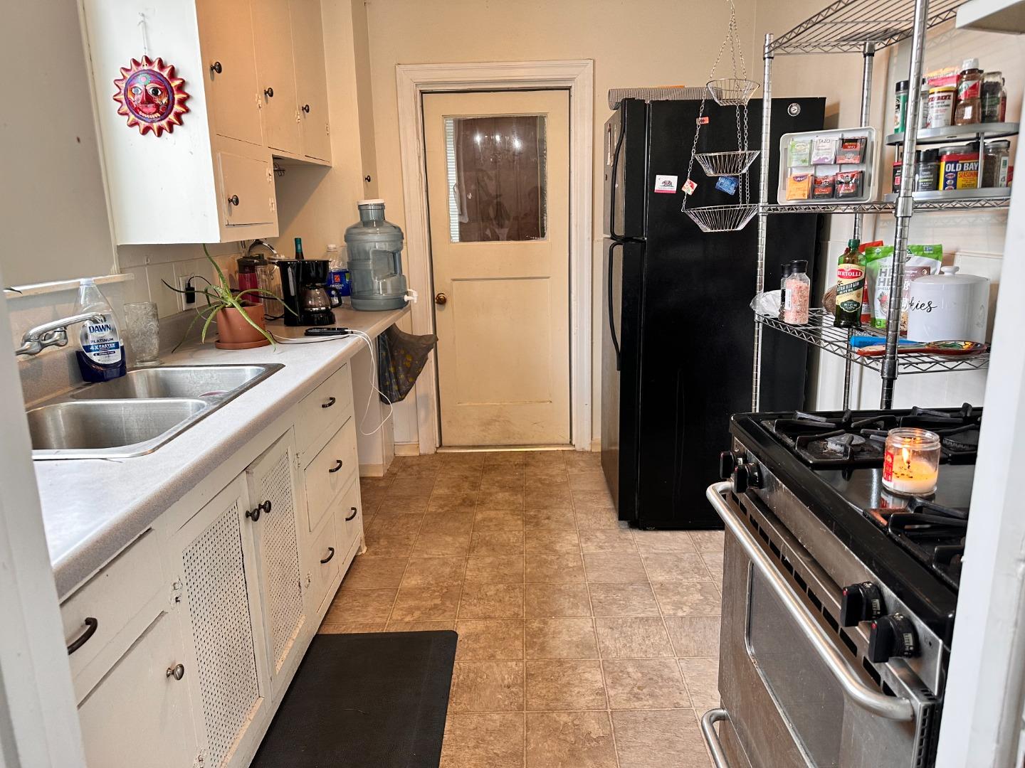 323 Maple Street Salinas, CA 93901 - Photo 7 of 15 a kitchen with white cabinets and appliances
