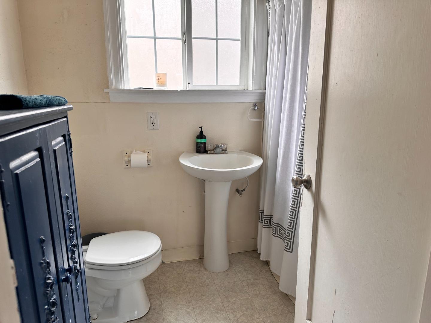 323 Maple Street Salinas, CA 93901 - Photo 10 of 15 a bathroom with a sink a toilet and shower