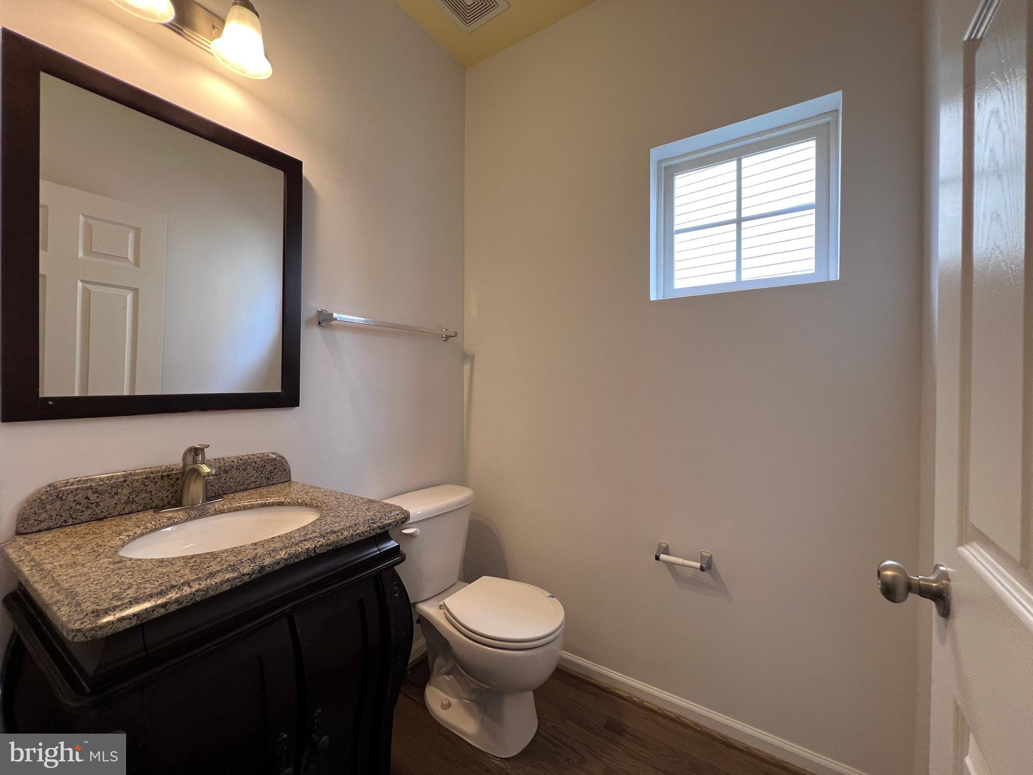 3925 Beeker Mill Place Chantilly, VA 20151 - Photo 14 of 40 a bathroom with a granite countertop toilet sink and mirror