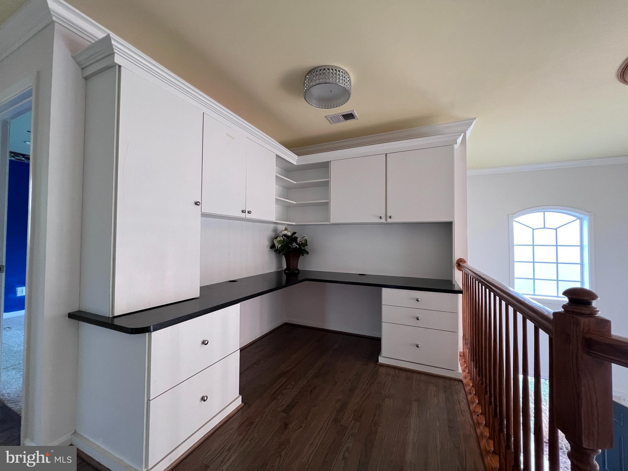 3925 Beeker Mill Place Chantilly, VA 20151 - Photo 15 of 40 a kitchen with granite countertop white cabinets and window