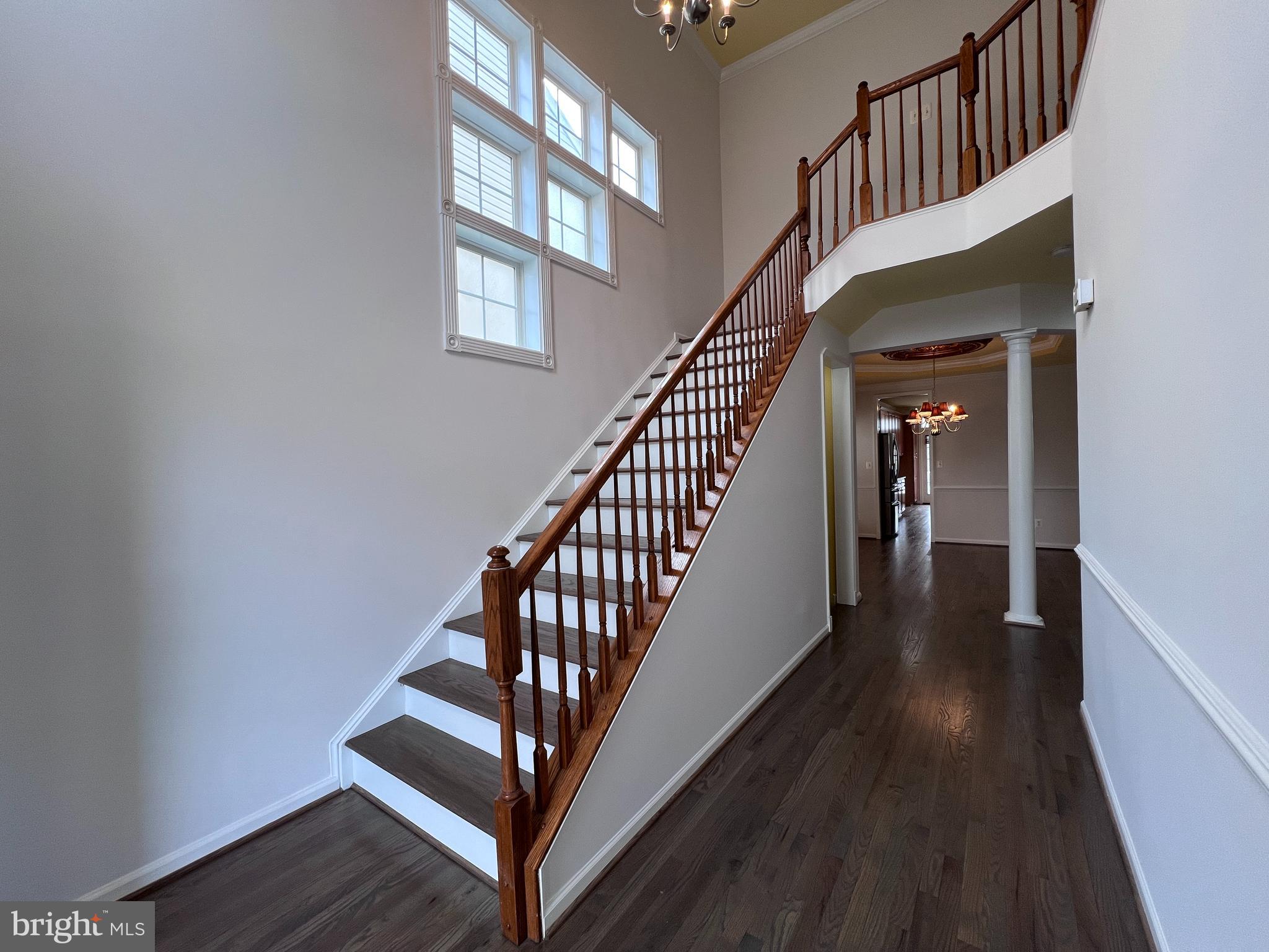 3925 Beeker Mill Place Chantilly, VA 20151 - Photo 3 of 40 a view of staircase with wooden floor and a window