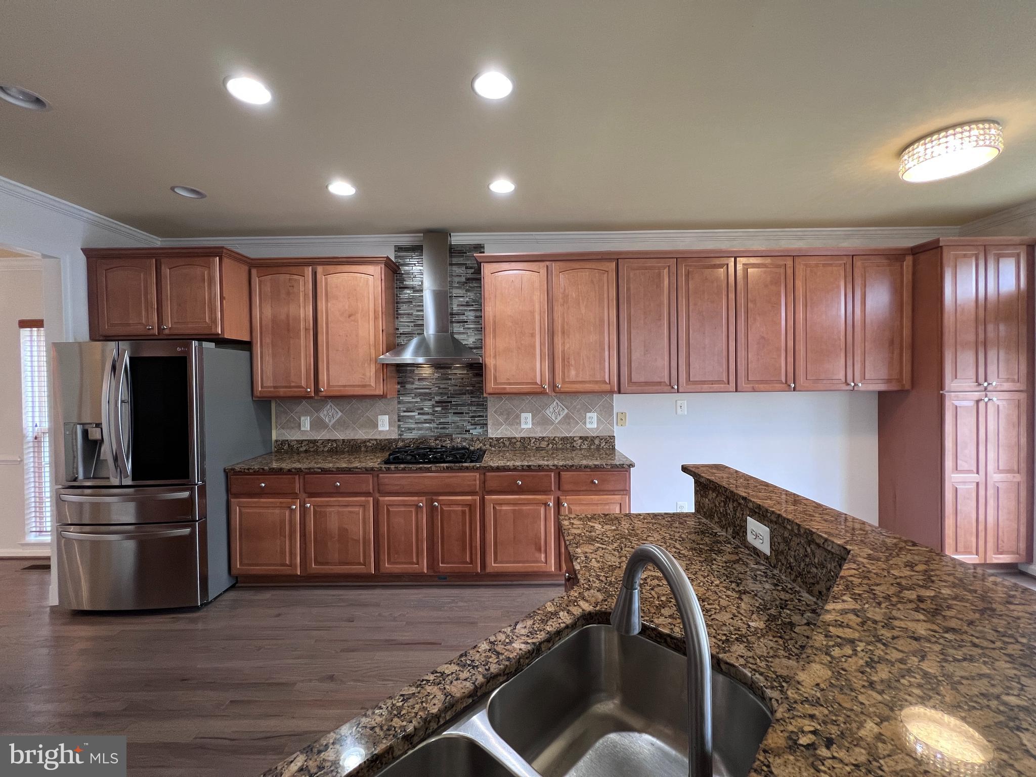 3925 Beeker Mill Place Chantilly, VA 20151 - Photo 7 of 40 a kitchen with granite countertop a stove and a refrigerator