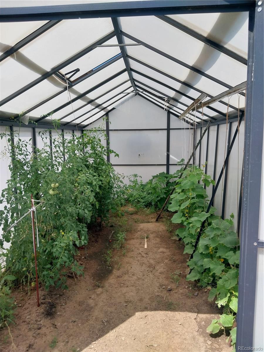 6642 Co Road Wiggins, CO 80654 - Photo 13 of 17 a backyard of a house with lots of green space
