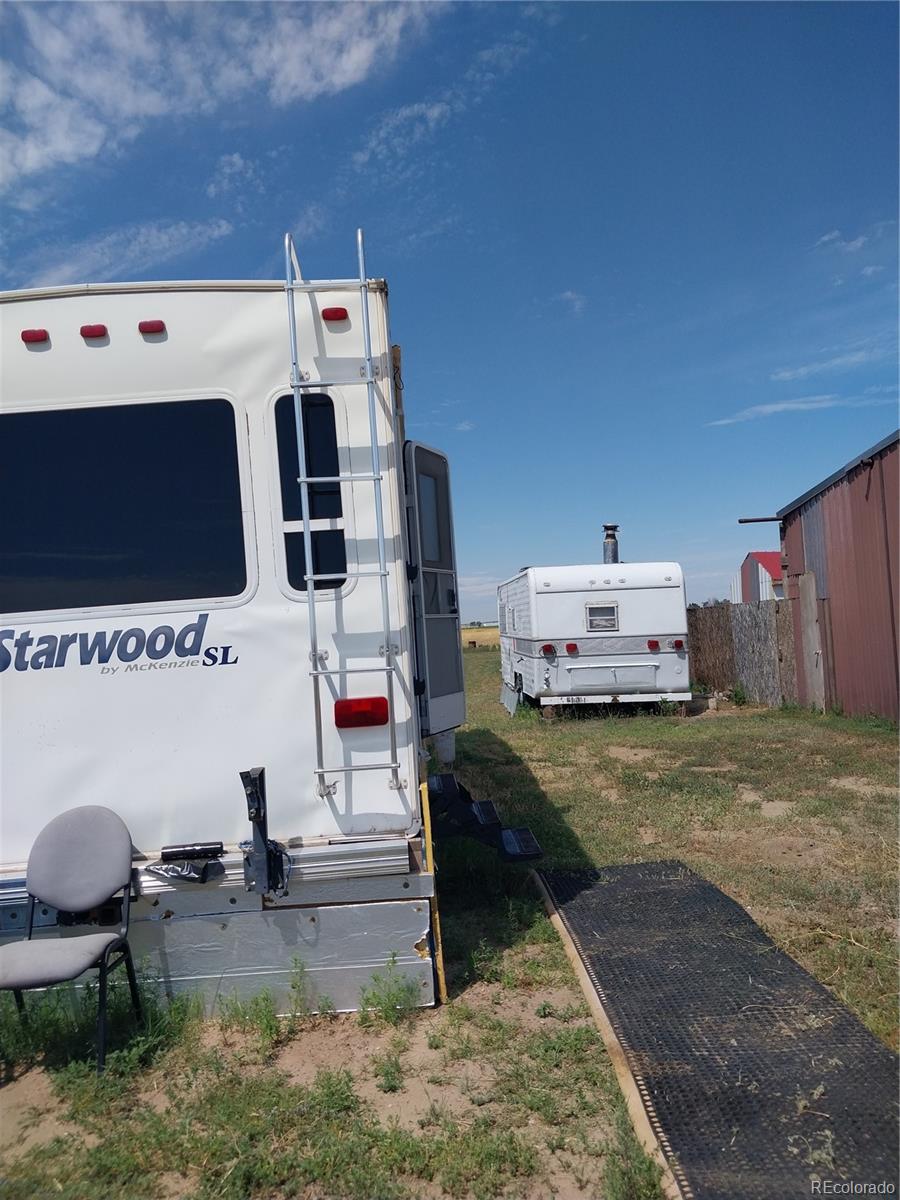 6642 Co Road Wiggins, CO 80654 - Photo 5 of 17 a view of living room with furniture and flat screen tv