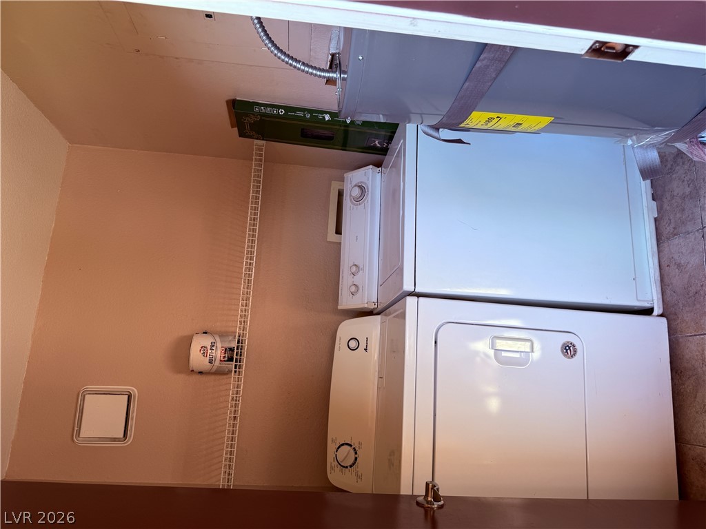 9325 West Desert Inn Road, Unit 260 Las Vegas, NV 89117 - Photo 23 of 42 Functional laundry setup, with stacked units in a dedicated utility space.