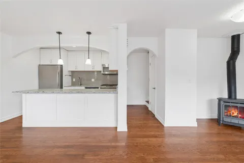 a kitchen with kitchen island stainless steel appliances a sink and a refrigerator