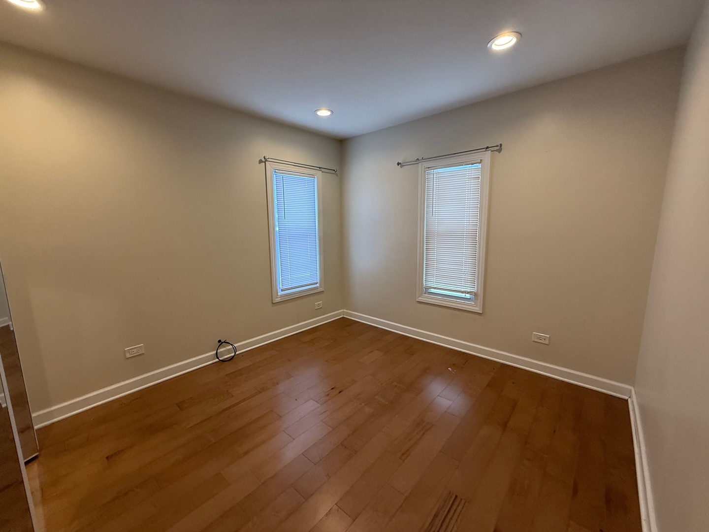 15036 West Russell Road Zion, IL 60099 - Photo 12 of 13 an empty room with wooden floor and windows