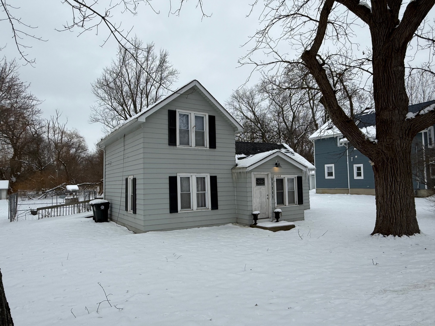15036 West Russell Road Zion, IL 60099 - Photo 13 of 13 a front view of a house with a yard covered in snow